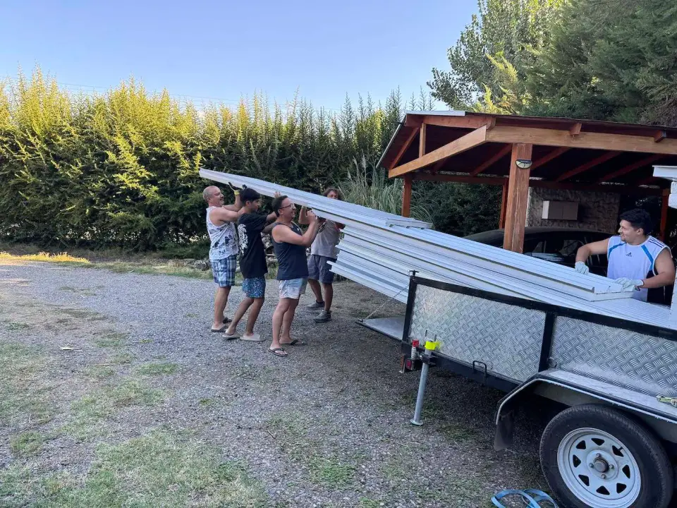 Amigos descargando paneles desde un carro para la bodega