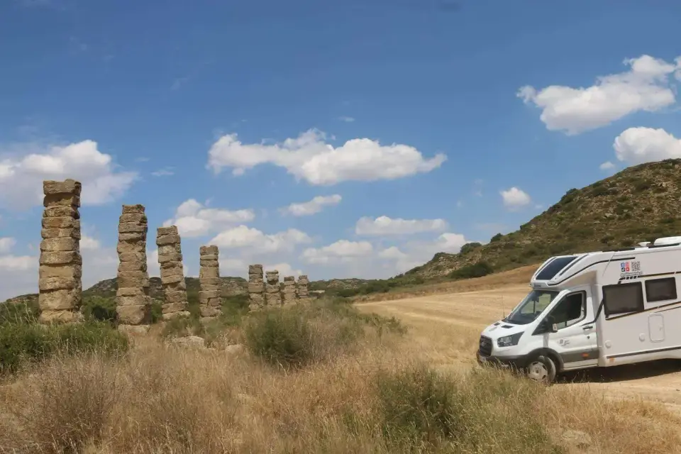 La autocaravana junto a los pilares del acueducto romano de Los Bañales
